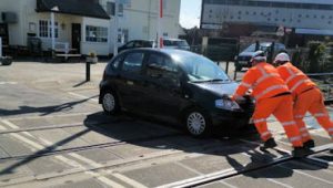 pushing the car clear of the level crossing