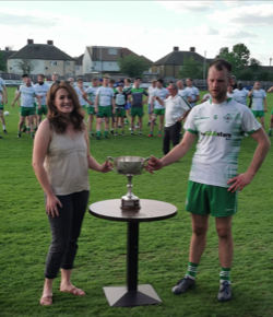 Shauna McKeon presents the cup to the winner of the GAA intermediate championship