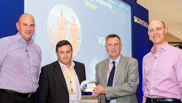 Chris and Laurence receiving the trophy at the Skanska supply chain award