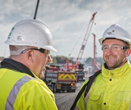 two men talking on construction site