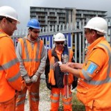 four workers in a safety briefing