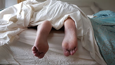 feet of someone in bed